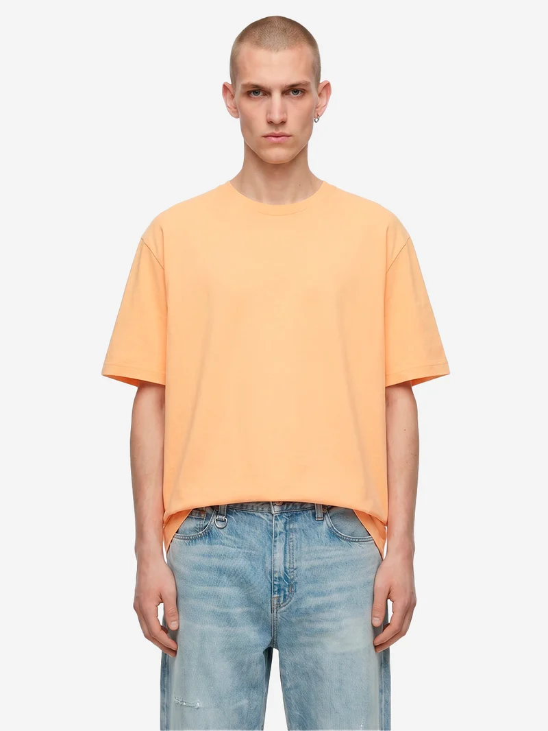 T-shirt in jersey di cotone arancione con logo CDG sul retro